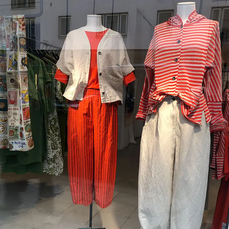 Fashion display featuring striped and solid outfits.