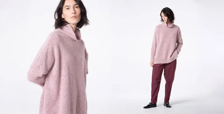 Model showcasing pink sweater and burgundy pants.
