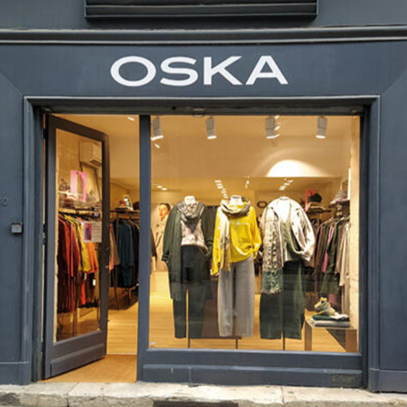 Clothing store display with stylish apparel.