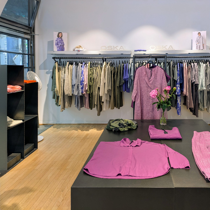 Clothing store display with purple garments