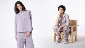 Two women modeling stylish outfits in a minimalist setting.