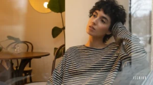 Thoughtful person in a cozy indoor setting.