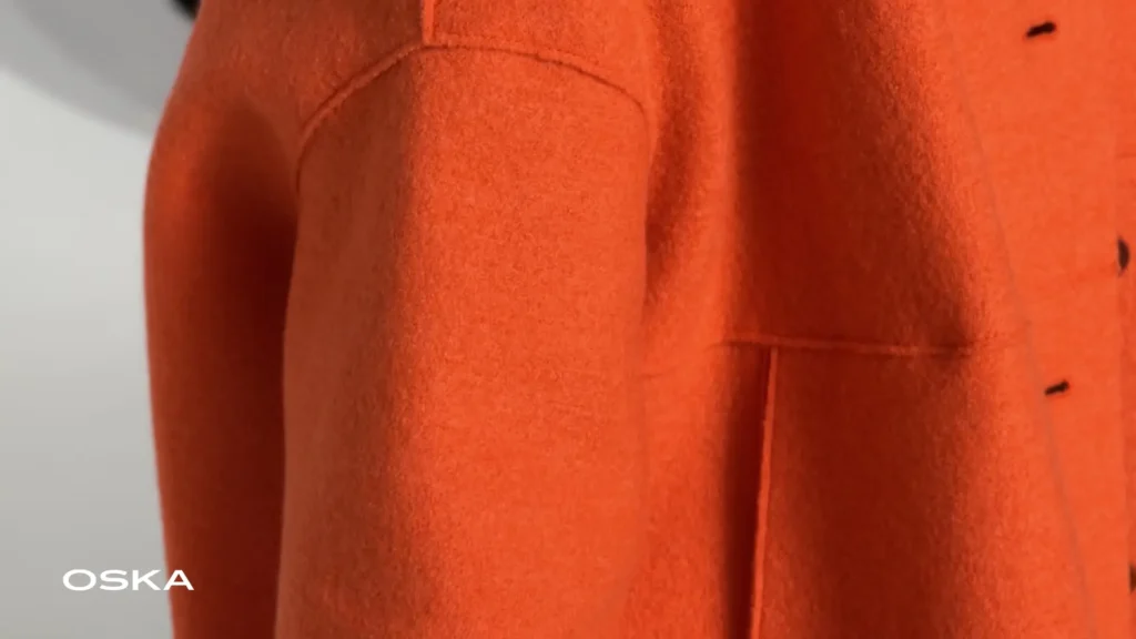 Close-up of an orange wool coat